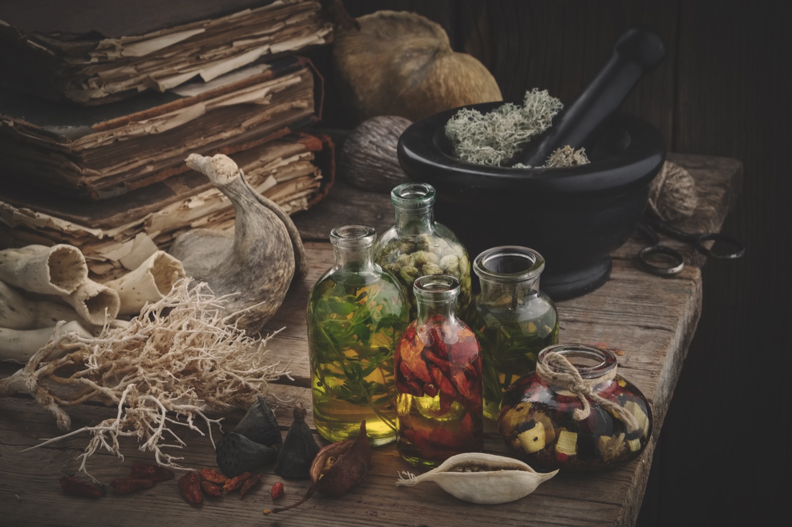 Apothecary still life with herbs, glass bottles and mortar
